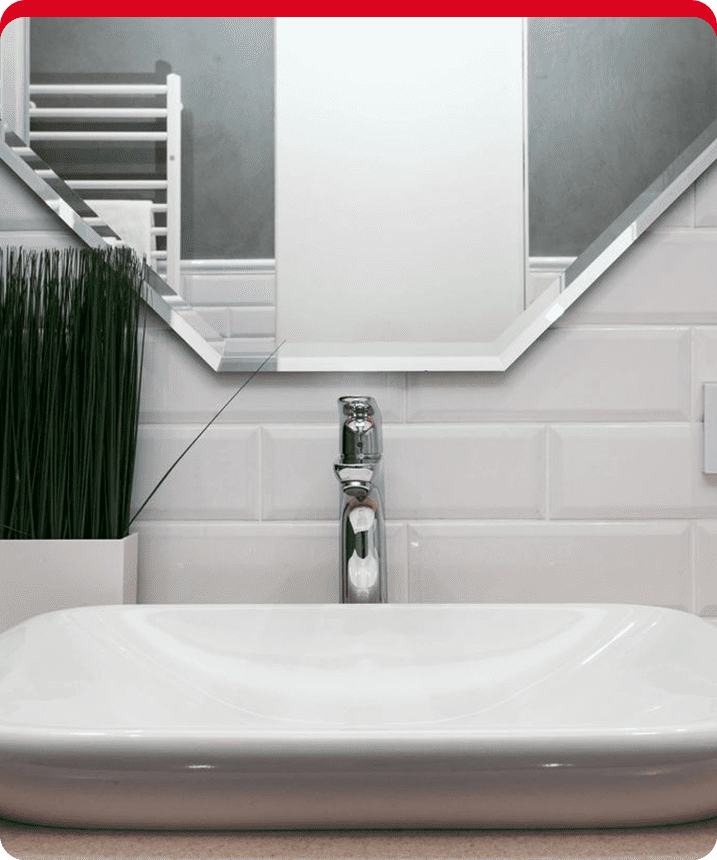 A white sink sitting under a bathroom mirror.