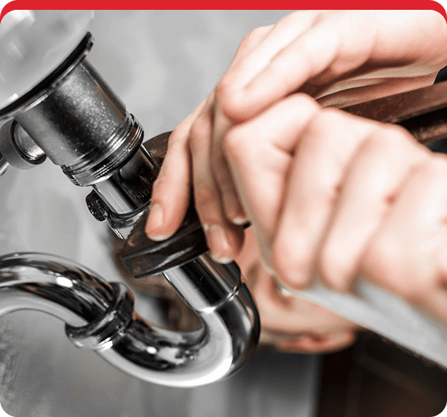 A person is fixing the faucet of a kitchen sink.