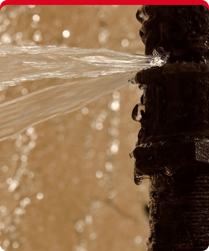 A close up of the water flowing out from a pipe