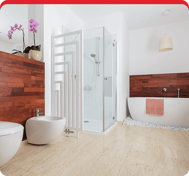 A bathroom with wood floors and white fixtures.