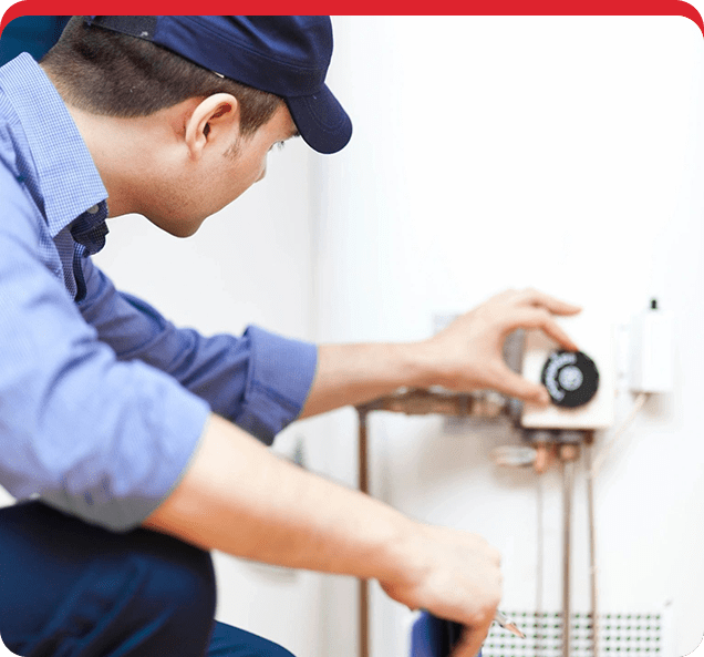 A man working on the outside of a water heater.