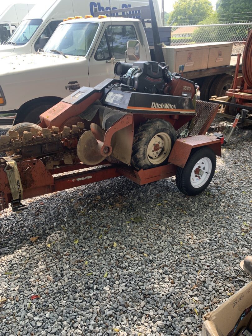 A small trailer with a log splitter on the side.